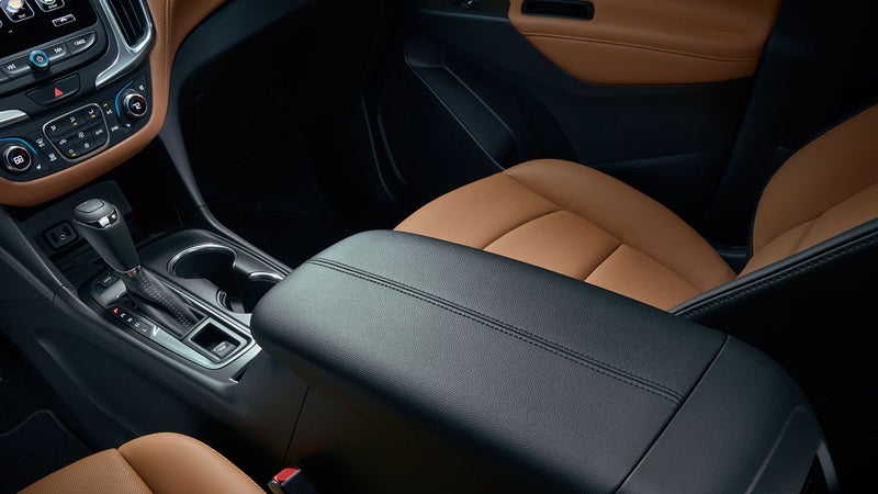Interior shot of the Chevrolet Equinox featuring the center console and tan leather seats.