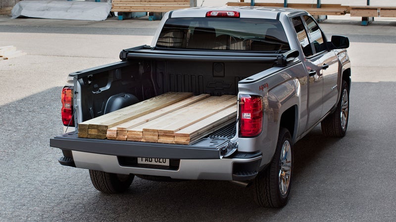 Chevrolet Silverado carrying a load of wood.