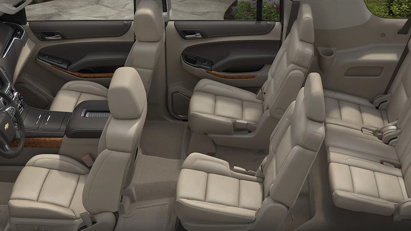 Interior seating layout of the 2017 Chevrolet Suburban with three rows of beige leather seats