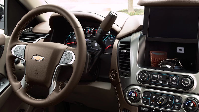 Dashboard and steering wheel of the 2017 Chevrolet Suburban featuring its infotainment system