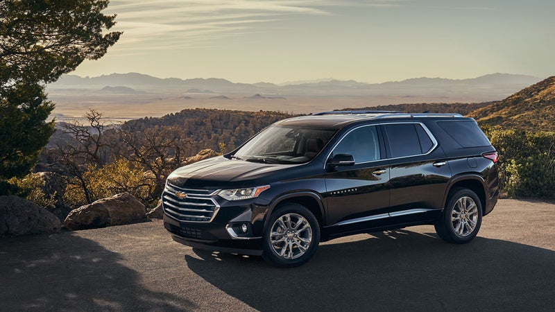 2018 Chevrolet Traverse parked near a scenic mountain overlook during sunset.