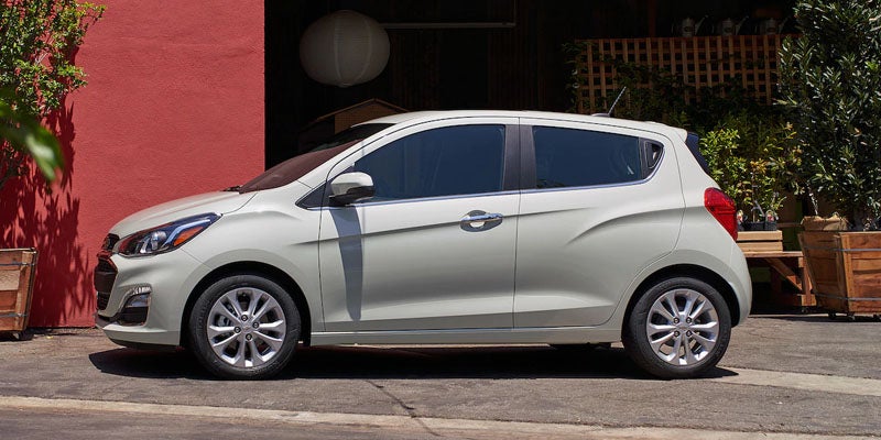 Chevrolet Spark parked by an apartment