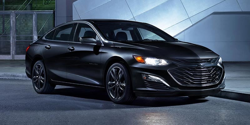 Black 2020 Chevrolet Malibu parked by an apartment