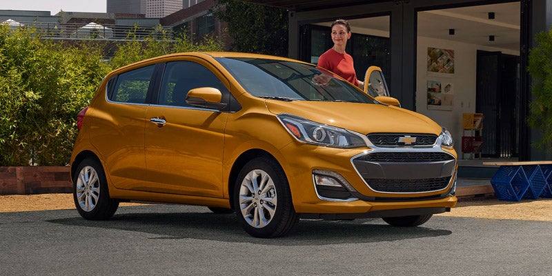 Chevrolet Spark parked in front of a house