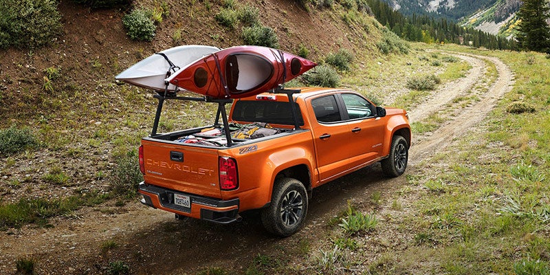 2021 Chevrolet Colorado carrying kayaks on a mountain trail