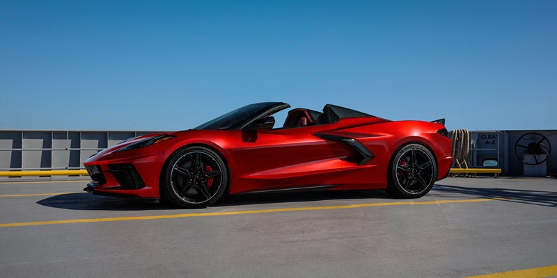 Side view of a red Chevrolet Corvette convertible parked on a rooftop