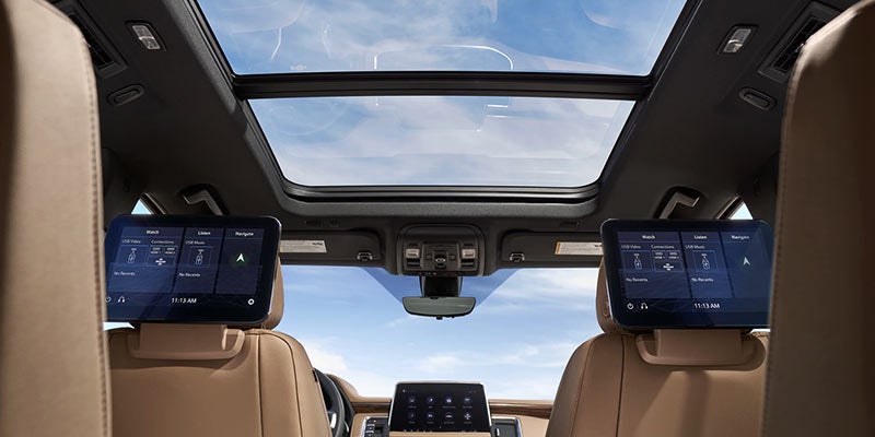 Chevrolet Suburban interior with glass roof and smart seat displays