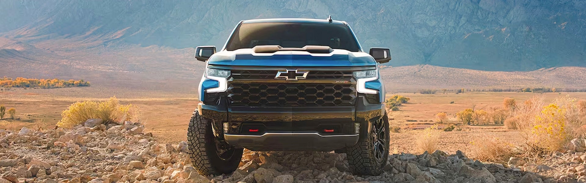 Front-facing view of the 2024 Chevrolet Silverado 1500 parked on rocky terrain
