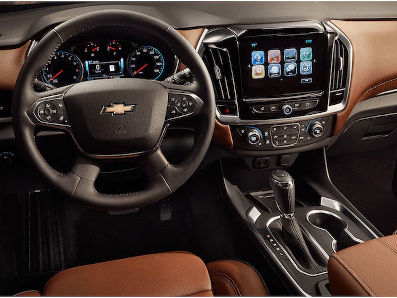 Chevrolet interior featuring modern dashboard with infotainment screen, climate controls, and brown leather seats.