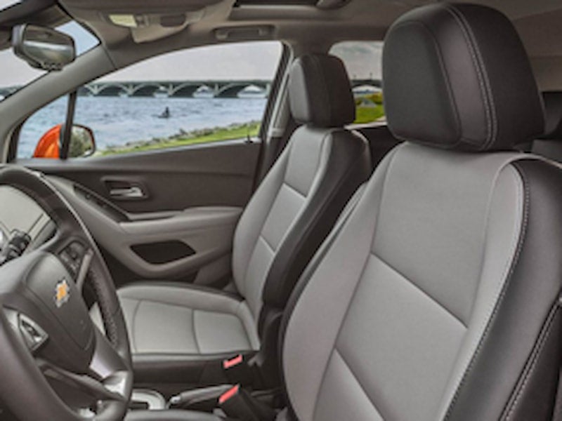 Front seats of the 2016 Chevrolet Trax in two-tone leather upholstery, viewed from passenger side.