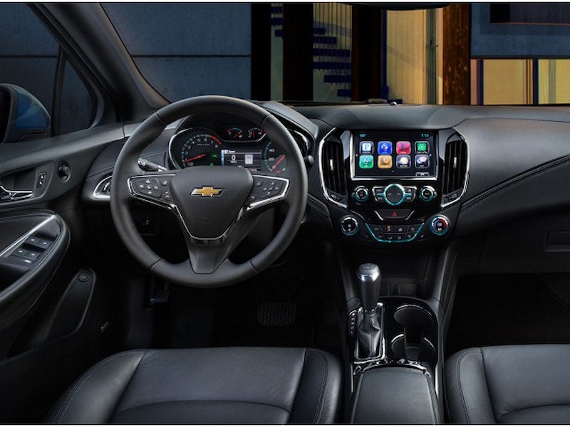 Interior view of the 2017 Chevrolet Cruze dashboard and steering wheel, featuring Chevrolet MyLink infotainment on an 8-inch display