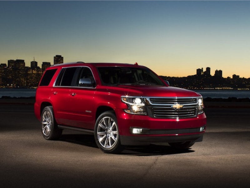 2017 Chevrolet Tahoe parked near a waterfront cityscape at dusk